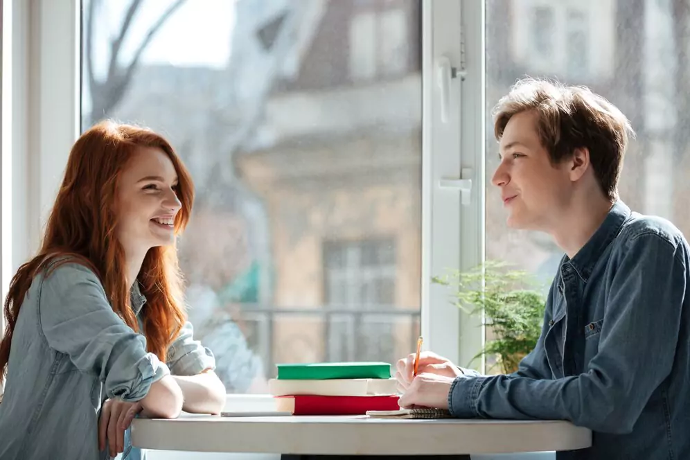 two-students-talking-cafe